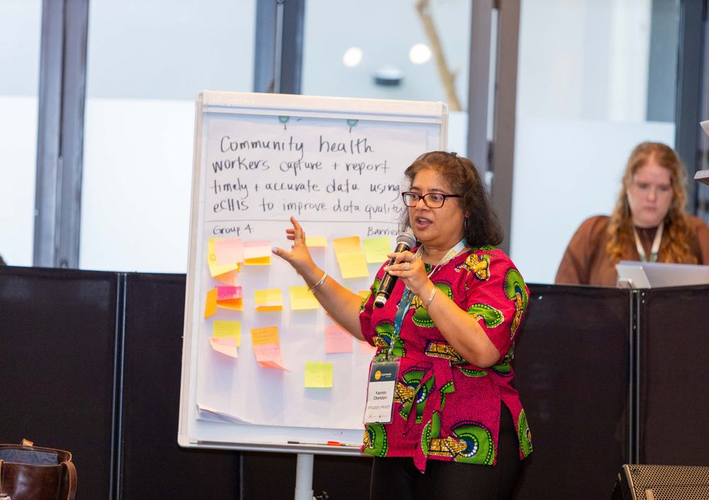 A facilitator presenting a community health workers flip chart at the Global Digital Health Forum